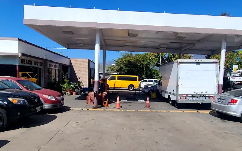 The covered yard at Beach Motor & Tires with a van, a box truck and customer cars waiting