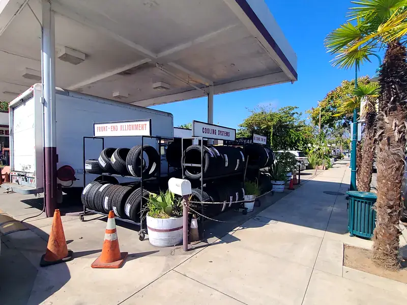Racks of new tires under the canopy out front